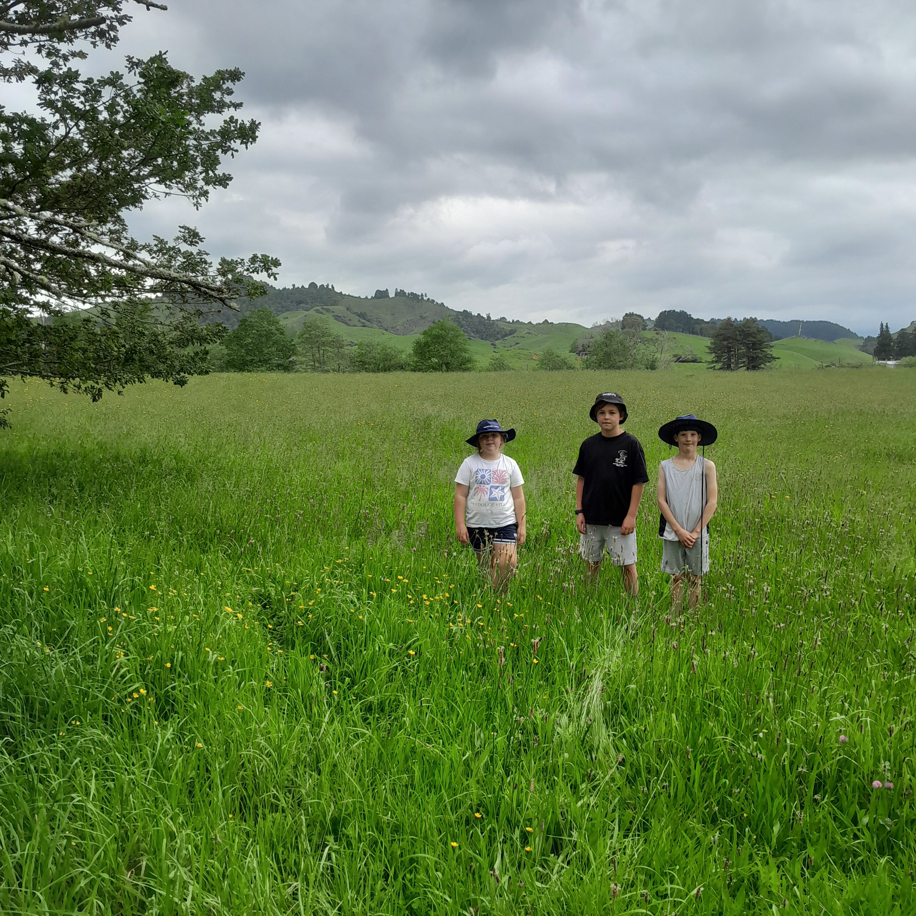 Three Waitetuna School students Tilly, Xander and Ollie where the pump track will be built on part of Waitetuna Reserve