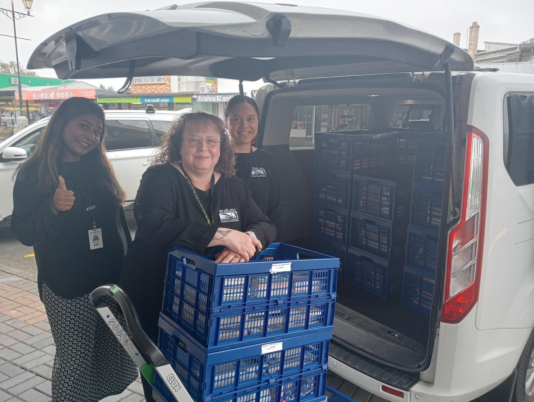 Library staff load the books into the van